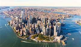 Aerial view of the skyline of New York City, New York, US, showing Manhattan Island and major infrastructure. (Image: Adobe Stock)